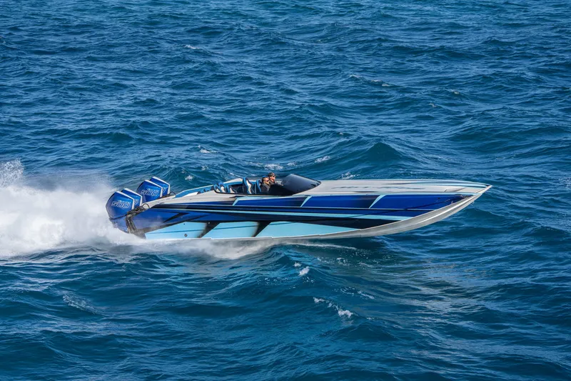 Slide: The Image of 2026 Nor-Tech 4000 Super Catamaran speeding on open water, showcasing sleek design. - 53