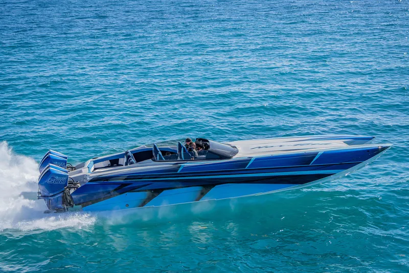 Slide: The Image of 2026 Nor-Tech 4000 Super Catamaran speeding on clear blue ocean waters. - 58