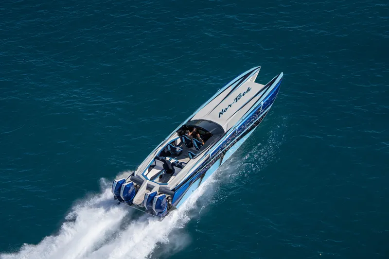 Slide: The Image of 2026 Nor-Tech 4000 Super Catamaran speeding on open water, showcasing sleek design and power. - 71