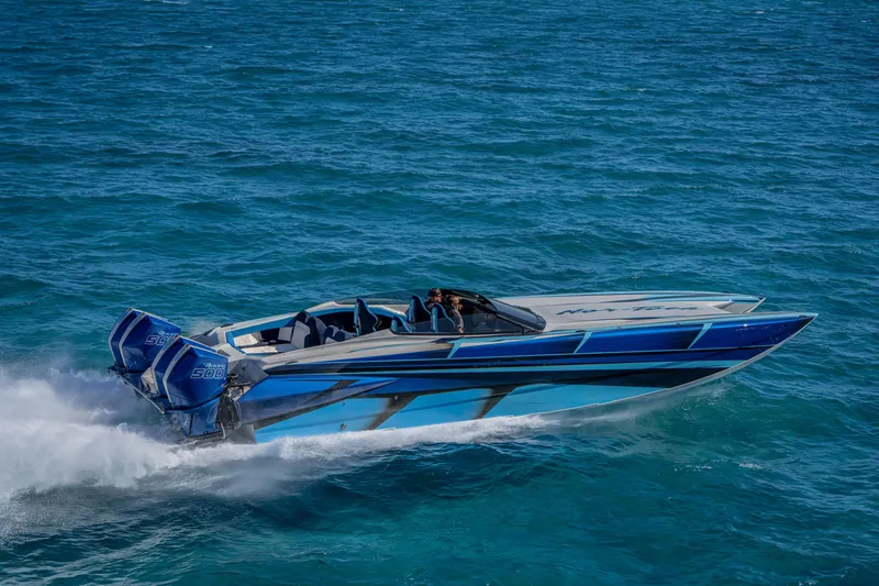Slide: The Image of 2026 Nor-Tech 4000 Super Catamaran speeding on open water, showcasing sleek design and powerful engines. - 82