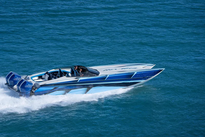 Slide: The Image of 2026 Nor-Tech 4000 Super Catamaran speeding on open water, showcasing sleek design. - 86