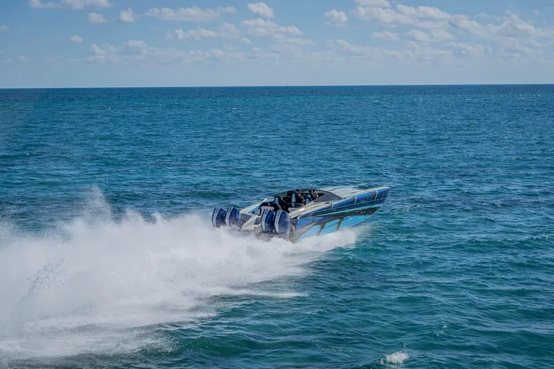 Slide: The Image of 2026 Nor-Tech 4000 Super Catamaran speeding on open ocean under clear skies. - 95