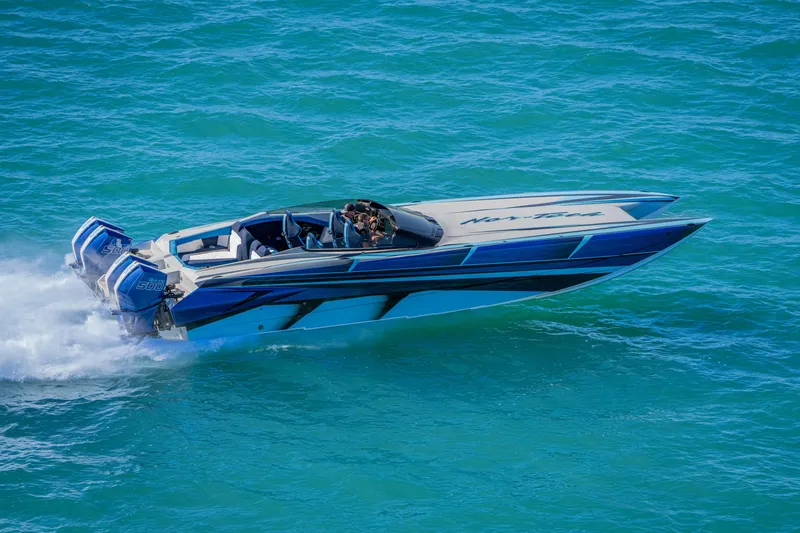 Slide: The Image of 2026 Nor-Tech 4000 Super Catamaran speeding on turquoise water, showcasing sleek design and power. - 98