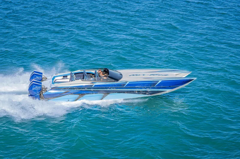 Slide: The Image of 2026 Nor-Tech 4000 Super Catamaran speeding on blue ocean waters. - 99