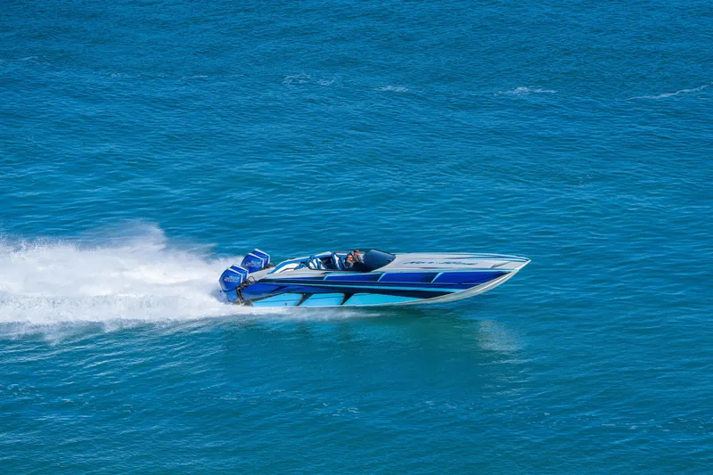 Slide: The Image of 2026 Nor-Tech 4000 Super Catamaran speeding on blue ocean waters. - 1