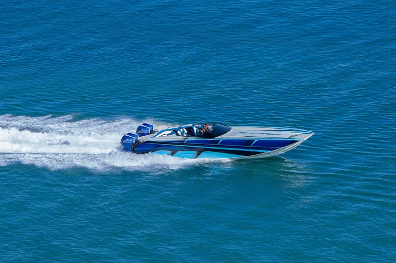Slide: The Image of 2026 Nor-Tech 4000 Super Catamaran speeding on blue ocean waters. - 102