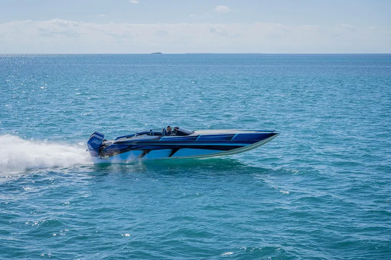 Slide: The Image of 2026 Nor-Tech 4000 Super Catamaran speeding on open blue ocean waters. - 111