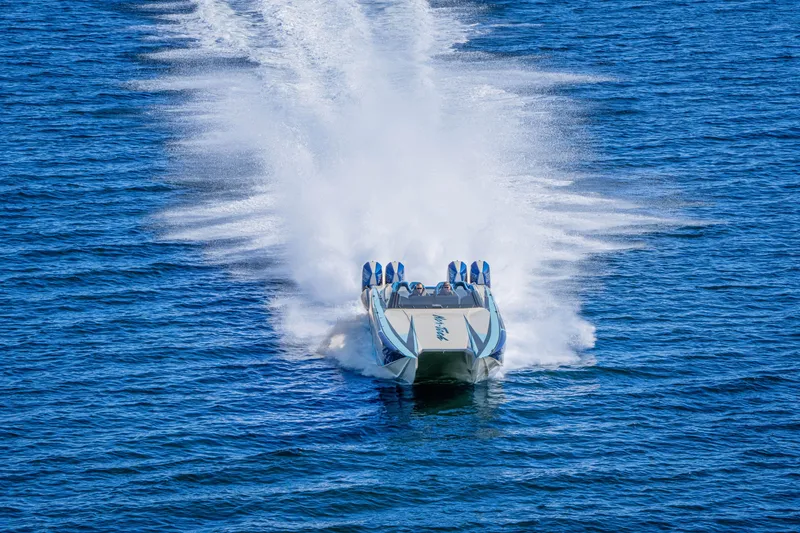 Slide: The Image of 2026 Nor-Tech 4000 Super Catamaran speeding across blue ocean waters. - 114