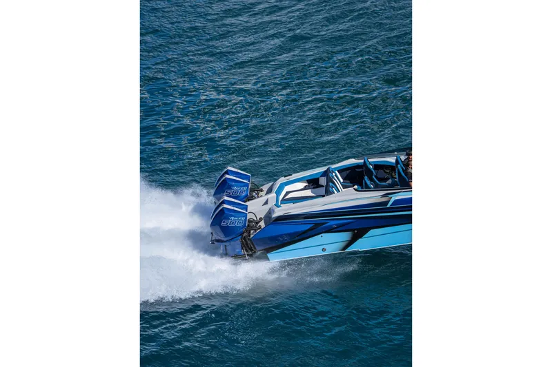 Slide: The Image of 2026 Nor-Tech 4000 Super Catamaran speeding on water, showcasing sleek design and powerful engines. - 122