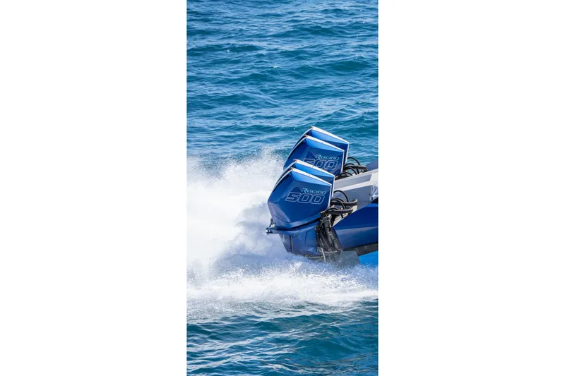 Slide: The Image of 2026 Nor-Tech 4000 Super Catamaran with powerful outboard engines on blue ocean. - 125