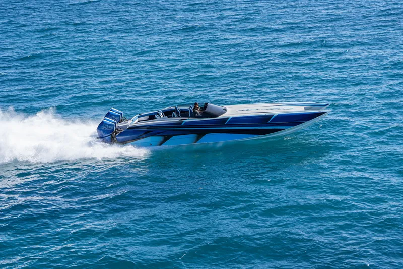 Slide: The Image of 2026 Nor-Tech 4000 Super Catamaran speeding on open water, showcasing sleek design and power. - 126