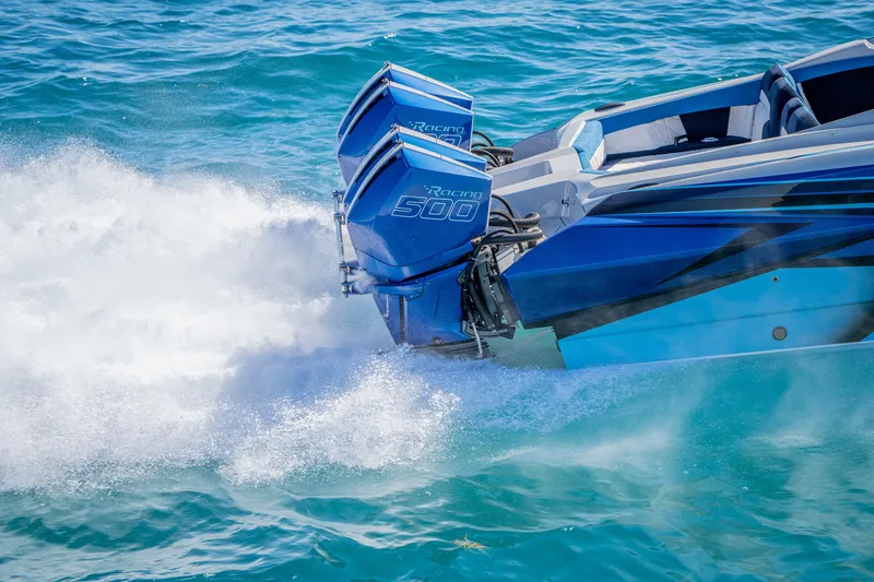 Slide: The Image of 2026 Nor-Tech 4000 Super Catamaran with dual Racing 500 engines on turquoise water. - 13