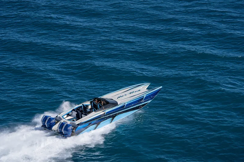 Slide: The Image of 2026 Nor-Tech 4000 Super Catamaran speeding on open blue ocean waters. - 140