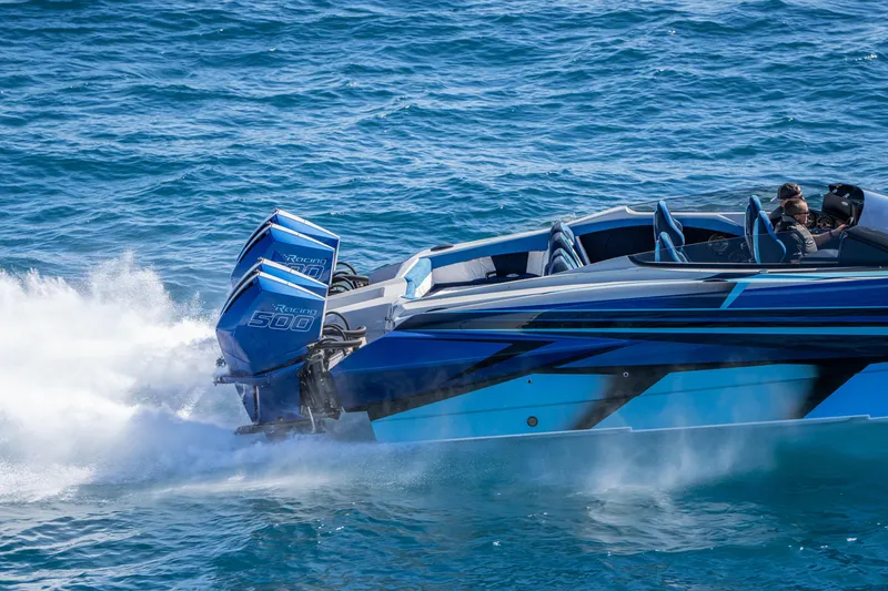 Slide: The Image of 2026 Nor-Tech 4000 Super Catamaran speeding on blue ocean waters. - 143