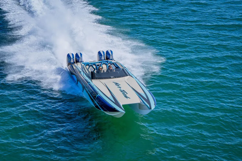 Slide: The Image of 2026 Nor-Tech 4000 Super Catamaran speeding on open water, showcasing sleek design and power. - 150