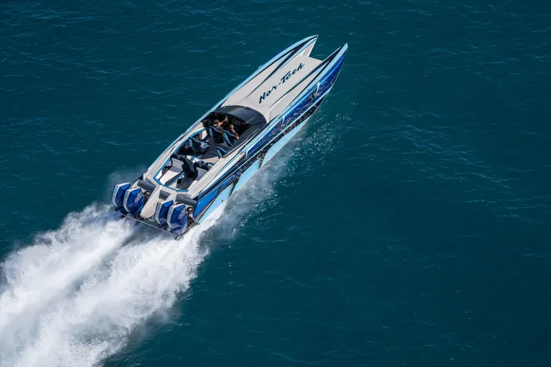 Slide: The Image of 2026 Nor-Tech 4000 Super Catamaran speeding on open water, showcasing sleek design. - 153