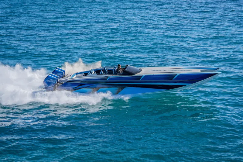 Slide: The Image of 2026 Nor-Tech 4000 Super Catamaran speeding on open water, showcasing sleek design. - 157