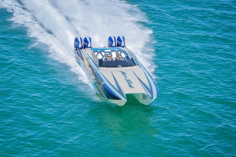 Slide: The Image of 2026 Nor-Tech 4000 Super Catamaran speeding on clear blue water. - 163