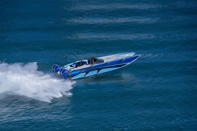 Slide: The Image of 2026 Nor-Tech 4000 Super Catamaran speeding on open water, showcasing sleek design. - 168