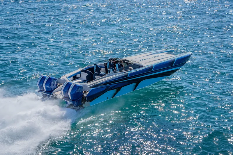 Slide: The Image of 2026 Nor-Tech 4000 Super Catamaran speeding on open water, showcasing sleek design and powerful engines. - 188