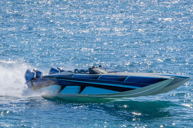 Slide: The Image of 2026 Nor-Tech 4000 Super Catamaran speeding on sparkling blue water. - 191
