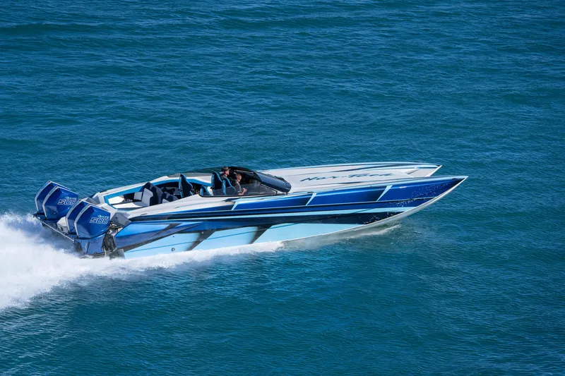 Slide: The Image of 2026 Nor-Tech 4000 Super Catamaran speeding on blue ocean waters. - 202