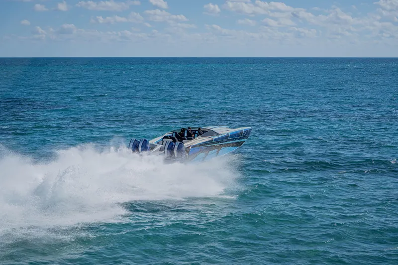 Slide: The Image of 2026 Nor-Tech 4000 Super Catamaran speeding across ocean waves under clear sky. - 209