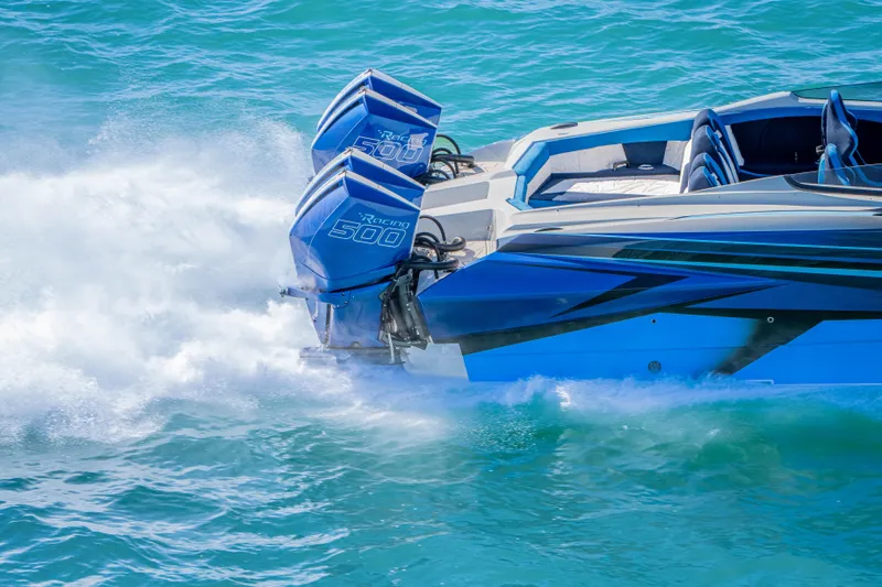 Slide: The Image of 2026 Nor-Tech 4000 Super Catamaran with twin Racing 500 engines on turquoise water. - 212