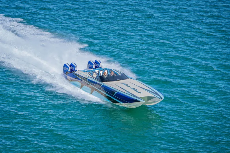 Slide: The Image of 2026 Nor-Tech 4000 Super Catamaran speeding on open water, showcasing sleek design and power. - 214