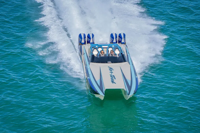 Slide: The Image of 2026 Nor-Tech 4000 Super Catamaran speeding on turquoise water. - 215