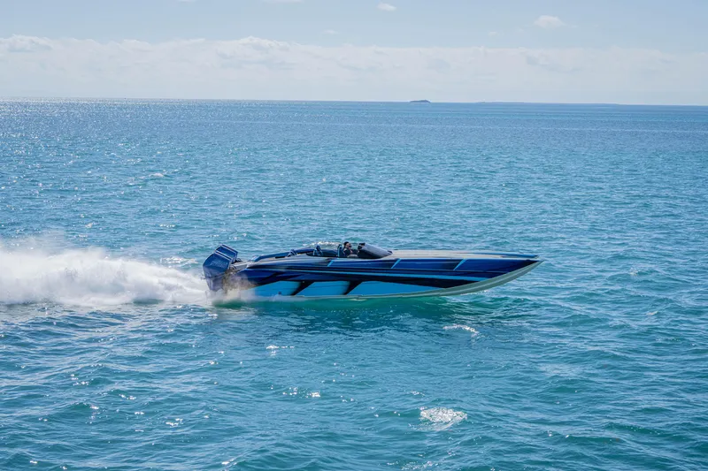 Slide: The Image of 2026 Nor-Tech 4000 Super Catamaran speeding on open blue ocean waters. - 30