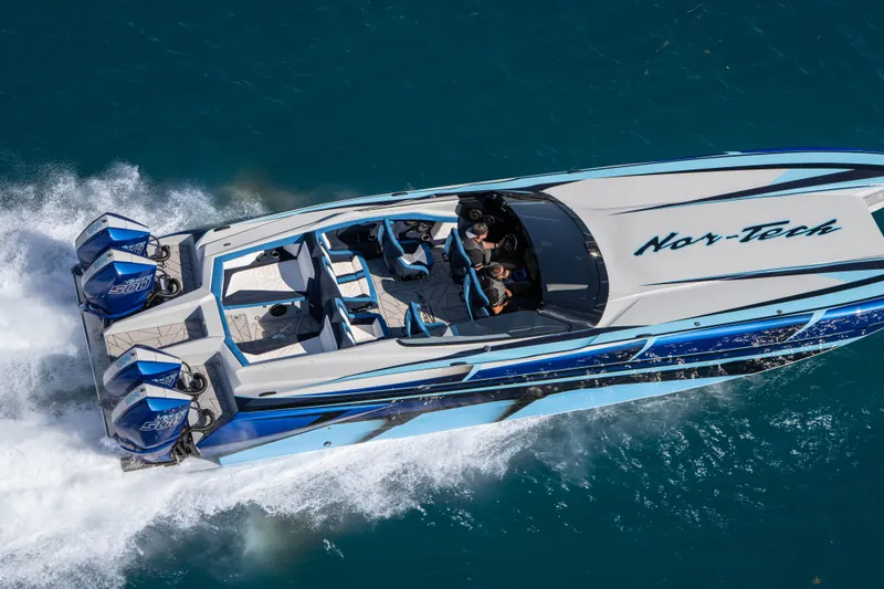 Slide: The Image of 2026 Nor-Tech 4000 Super Catamaran speeding on blue water, showcasing sleek design and powerful engines. - 51