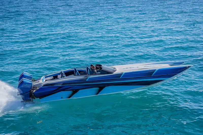 Slide: The Image of 2026 Nor-Tech 4000 Super Catamaran speeding on clear blue ocean waters. - 57