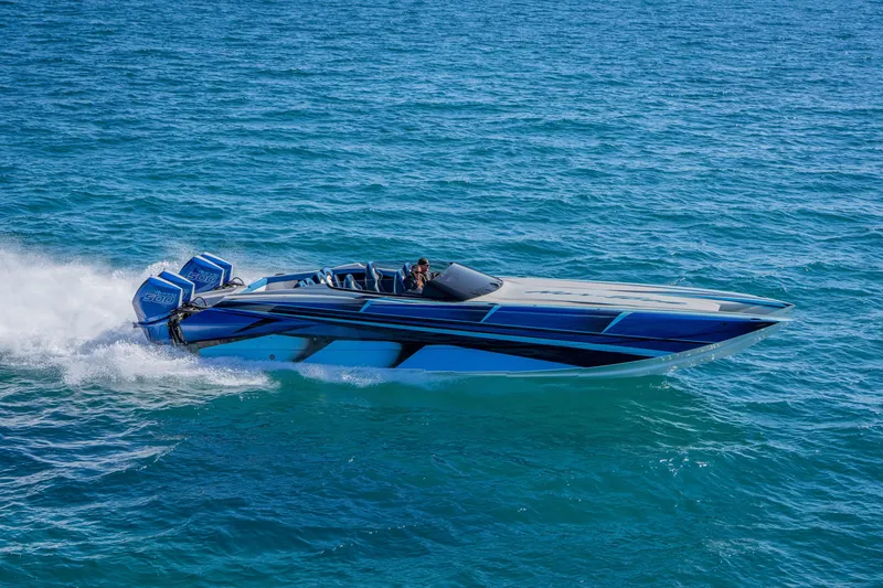 Slide: The Image of 2026 Nor-Tech 4000 Super Catamaran speeding on open water, showcasing sleek design. - 60