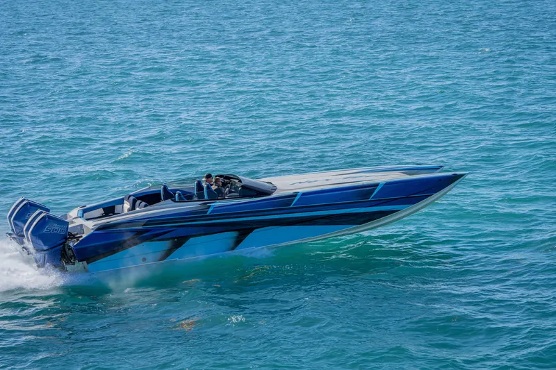 Slide: The Image of 2026 Nor-Tech 4000 Super Catamaran speeding on open water, showcasing sleek design and power. - 61