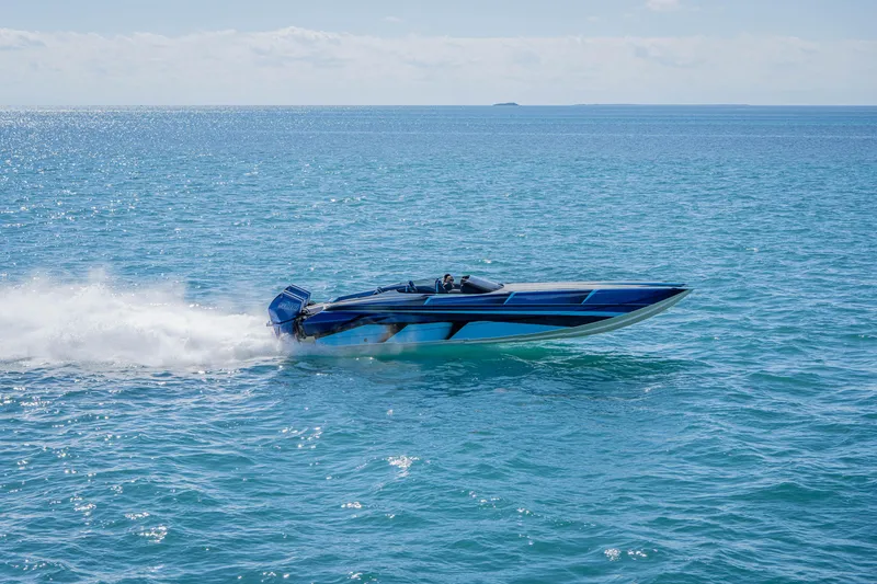 Slide: The Image of 2026 Nor-Tech 4000 Super Catamaran speeding on open blue ocean waters. - 64