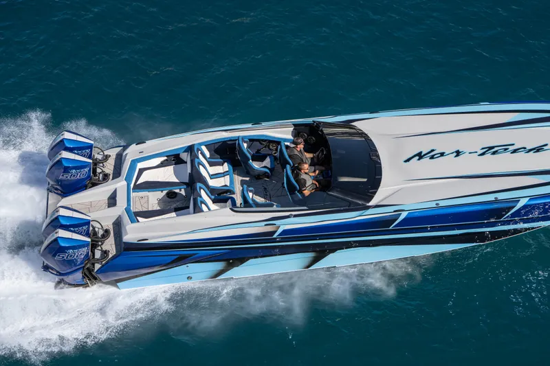 Slide: The Image of 2026 Nor-Tech 4000 Super Catamaran speeding on blue ocean waters. - 70