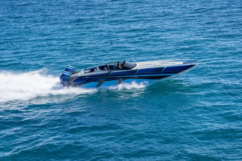Slide: The Image of 2026 Nor-Tech 4000 Super Catamaran speeding on open water, showcasing sleek design and power. - 76