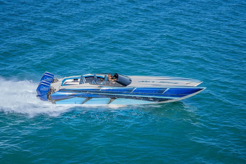 Slide: The Image of 2026 Nor-Tech 4000 Super Catamaran speeding on blue ocean waters. - 83