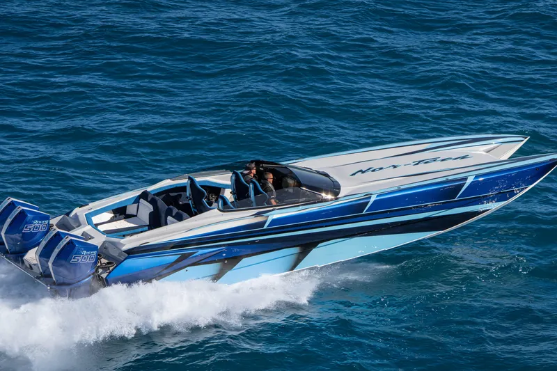 Slide: The Image of 2026 Nor-Tech 4000 Super Catamaran speeding on blue ocean waters. - 88