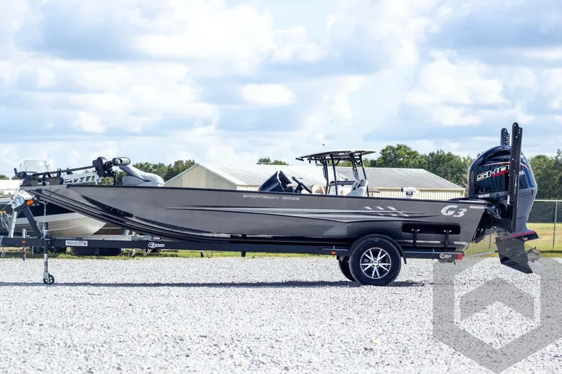 Slide: The Image of 2026 G3 Sportsman 1910 SE boat on trailer, parked outdoors under cloudy sky. - 11