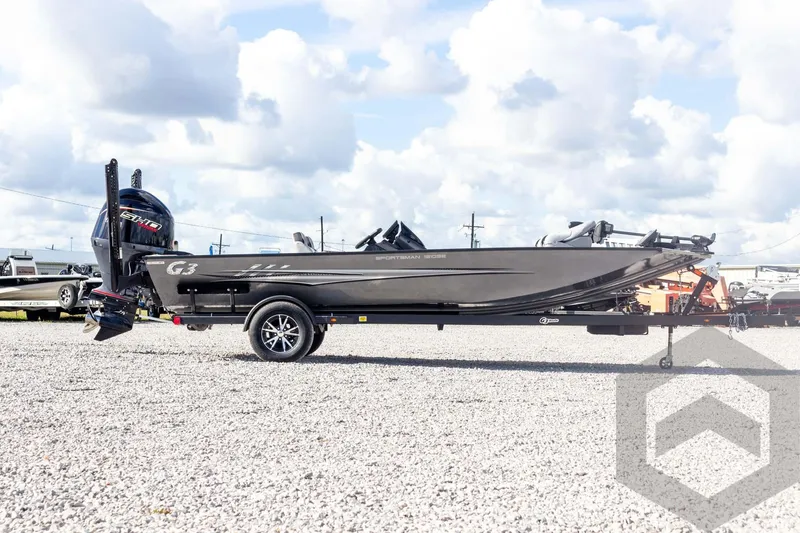 Slide: The Image of 2026 G3 Sportsman 1910 SE boat on trailer, parked on gravel lot under cloudy sky. - 15