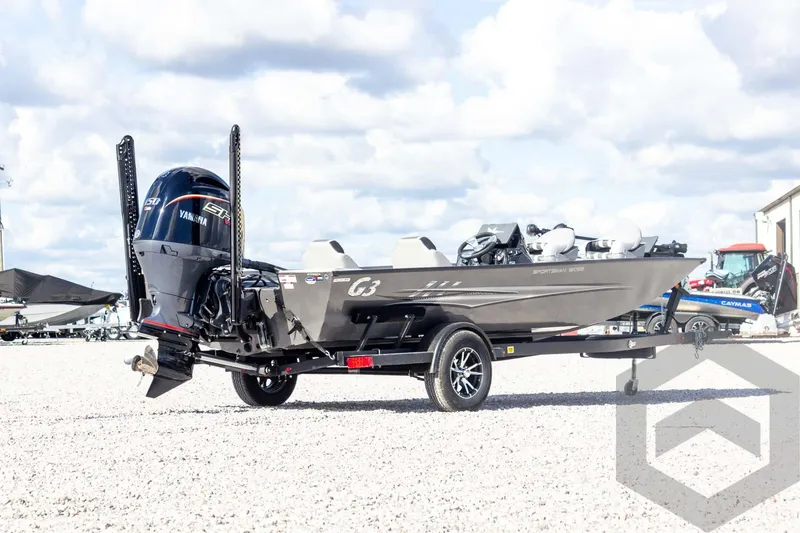 Slide: The Image of 2026 G3 Sportsman 1910 SE boat on trailer, parked outdoors under a cloudy sky. - 16