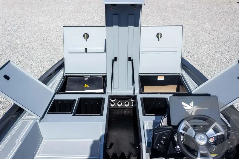 Slide: The Image of 2026 G3 Sportsman 1910 SE boat interior with open storage compartments and steering console. - 27