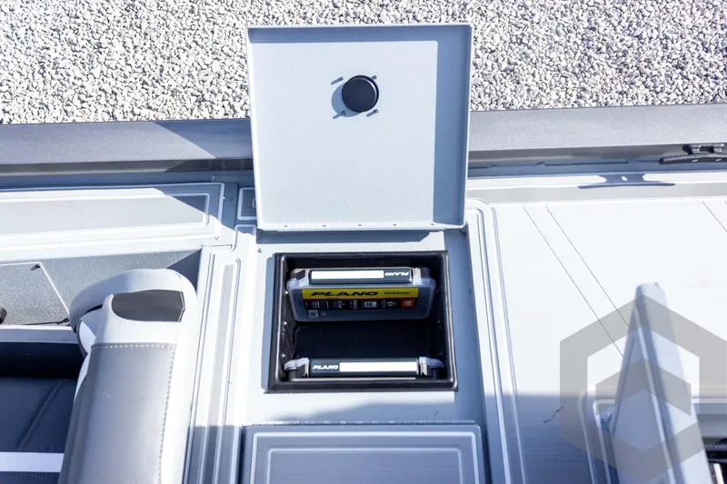 Slide: The Image of Open storage compartment on 2026 G3 Sportsman 1910 SE boat with Plano tackle box. - 52