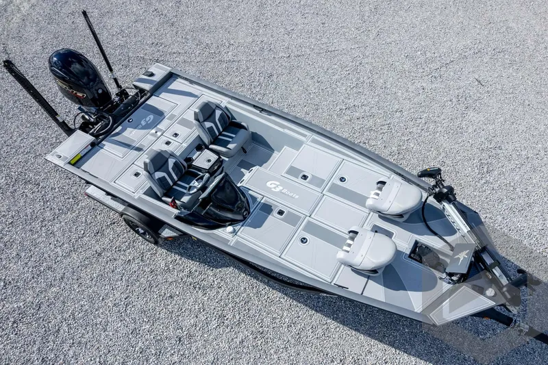Slide: The Image of 2026 G3 Sportsman 1910 SE boat, aerial view on gravel surface, showcasing sleek design. - 64