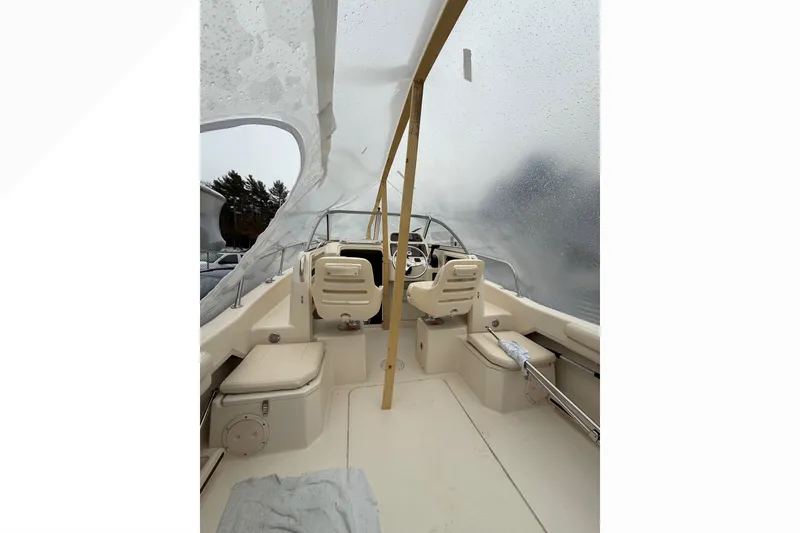 Slide: The Image of 2020 Grady-White Adventure 208 boat interior with covered seating and helm. - 13