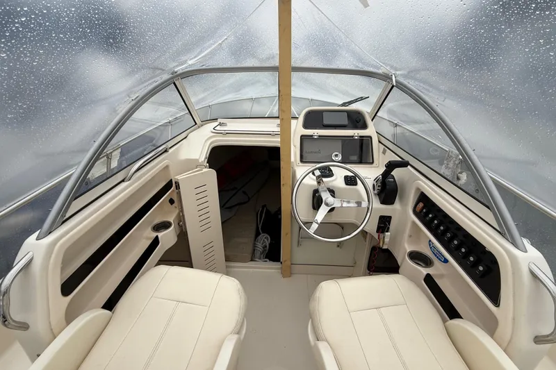 Slide: The Image of Interior view of 2020 Grady-White Adventure 208 boat cockpit with steering wheel and controls. - 14