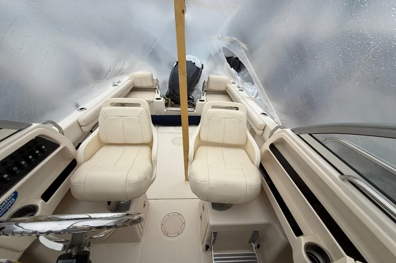 Slide: The Image of 2020 Grady-White Adventure 208 boat interior with white seating and covered deck. - 19