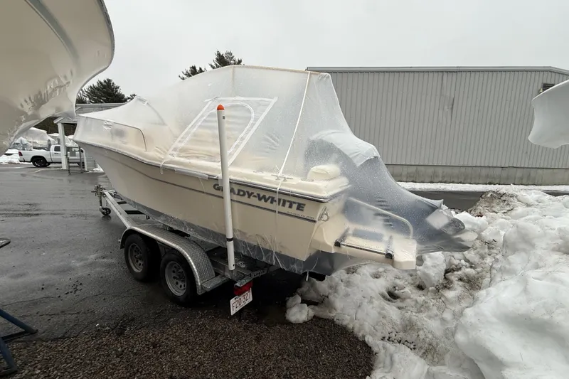 Slide: The Image of 2020 Grady-White Adventure 208 boat covered in protective wrap on a trailer in snowy conditions. - 25